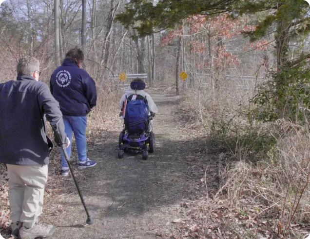 people with disabilities on a park trail
